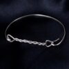 Twisted Arrow Ladies Bangle made from Eco Sterling Silver_From the front on black background