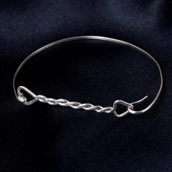 Twisted Arrow Ladies Bangle made from Eco Sterling Silver_From the front on black background