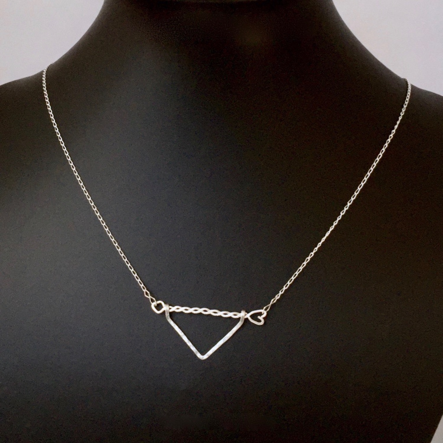Twisted Arrow Chevron Necklace_Black background scale model