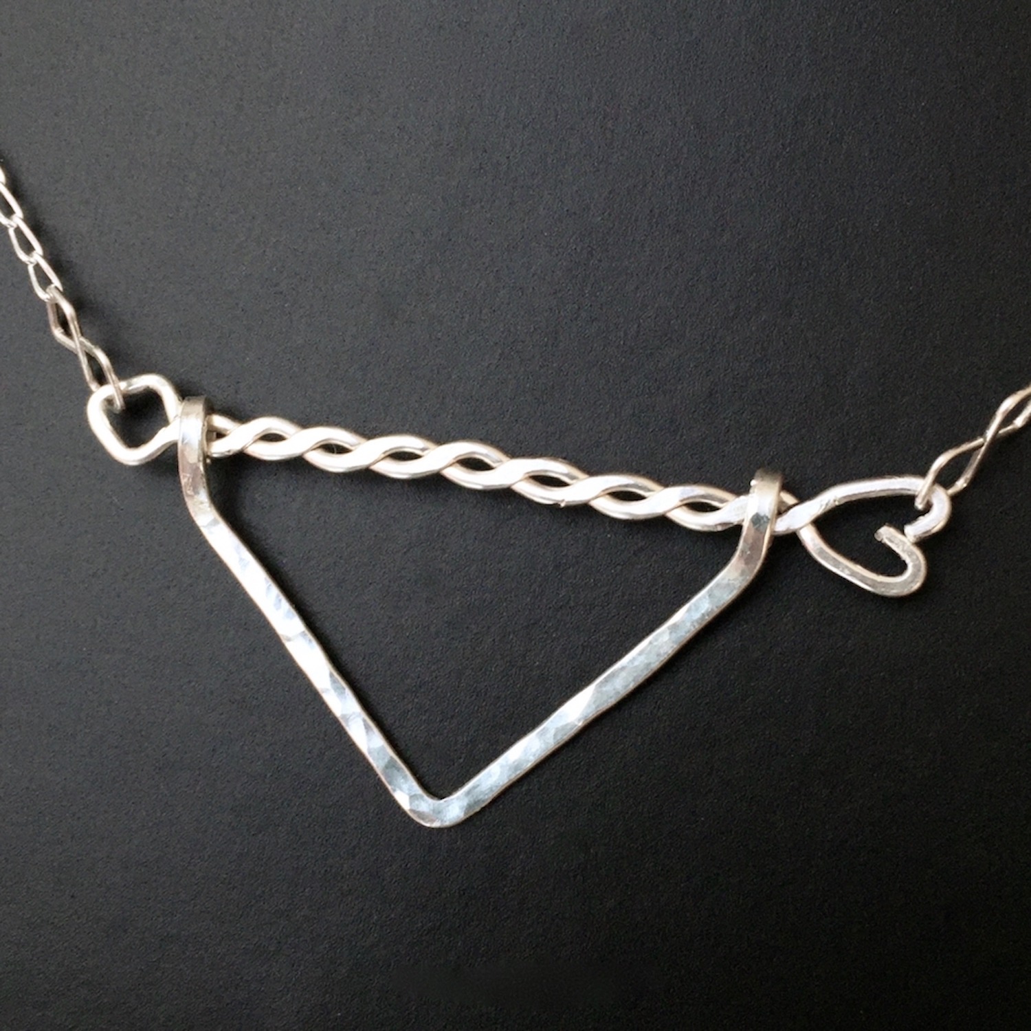 Twisted Arrow Chevron Necklace_Black background Close Up