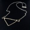 Twisted Arrow Chevron Necklace_Black background Flat Angle View