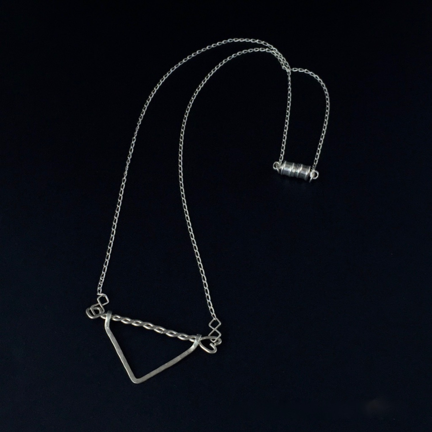 Twisted Arrow Chevron Necklace_Black background top view