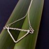 Twisted Arrow Chevron Necklace_Flax background