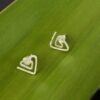 TriangleStuds_GreenCU Eco Silver Textured Triangle Spiral Studs against a green leaf background