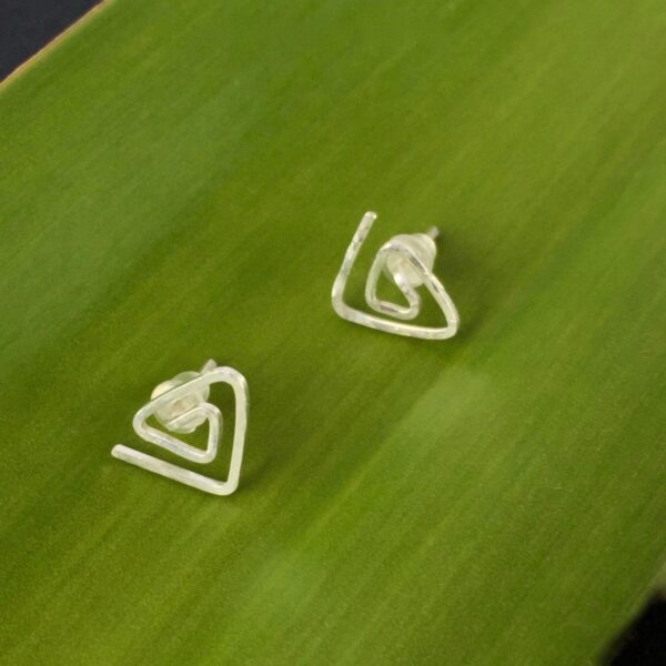 TriangleStuds_GreenCU Eco Silver Textured Triangle Spiral Studs against a green leaf background