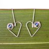 Close up of heart drop earrings showing iridescent Swarovski Crystals