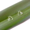 Koru Heart Studs in Eco Sterling Silver on flax leaf background