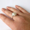 Diamond shaped ivory pearl ring being worn