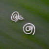 Close up of NZ Maori Koru Spiral Stud Earrings showing texture and catch the light