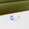 CornflowerBlueSwarovskiCrystals.8+3mm Cornflower Blue Swarovski Crystals 8mm and 3mm against white and flax background