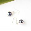 Flatlay image of the black freshwater pearl earrings wrapped in sterling silver