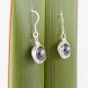 Side angle view of the black round pearl earrings in recycled sterling silver