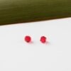 Ruby Red Swarovski Crystals 3mm and Bicone against white and flax background