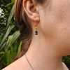 Model wearing multi coloured stone drop earrings