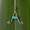 Adults letter necklace capital A with turquoise chips against green flax background