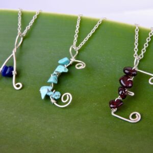 Initial letter necklaces capital A C E with semi precious stones attached