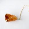 side view showing some dark coloured inclusions in New Zealand Amber necklace