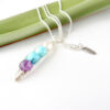 Angle view of customised birthstone necklace for April, 2 x December and February