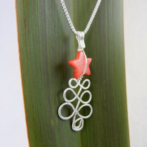 side angle view of Xmas necklace with red mother of pearl star