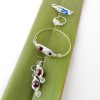 Peas in a Pod Birthstone Jewellery Collection shown on flax leaf flatly