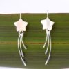 Mother of Pearl Wishing Star Eco Earrngs Close up of Wishing Star Earrings against flax background