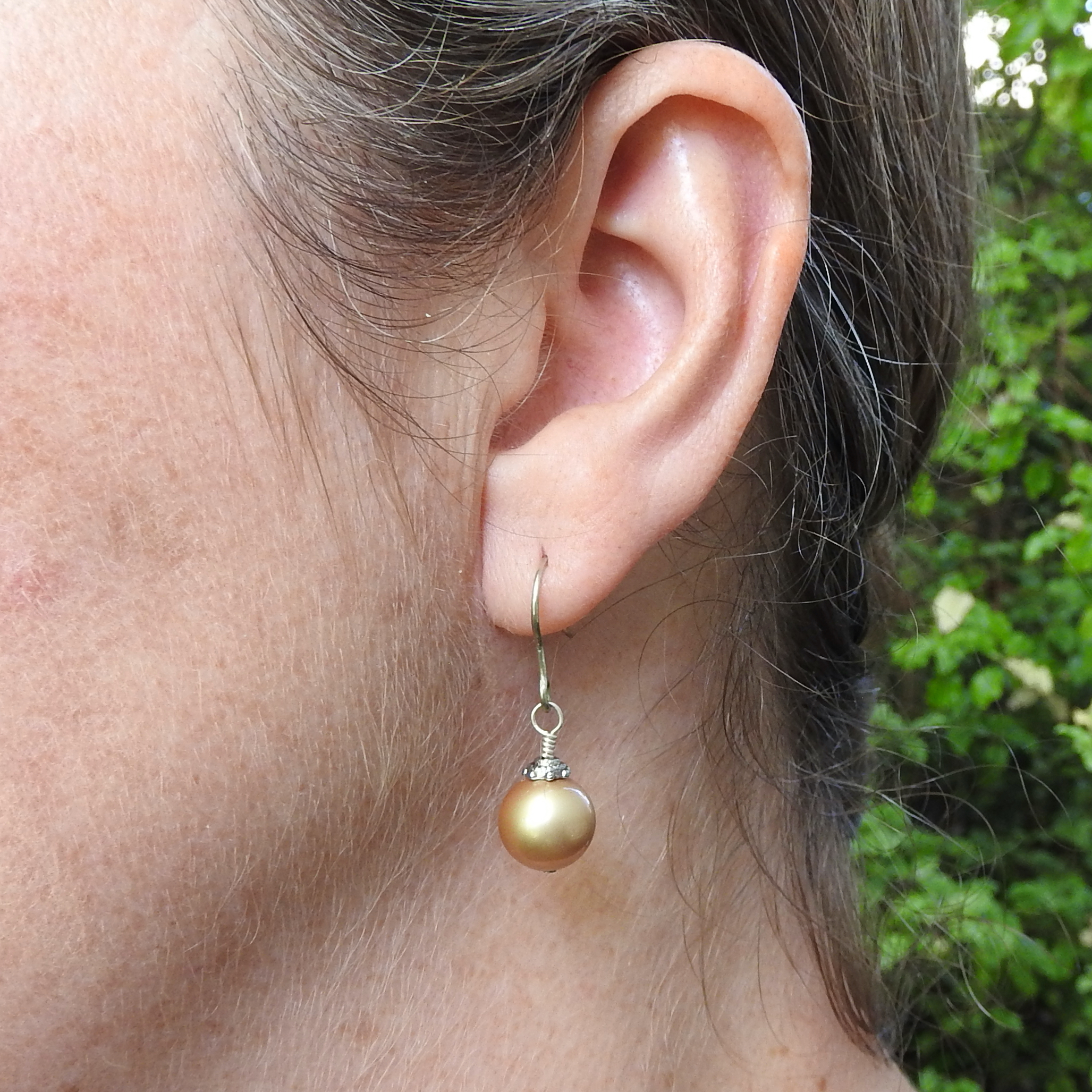 Gold Christmas Bauble being worn2