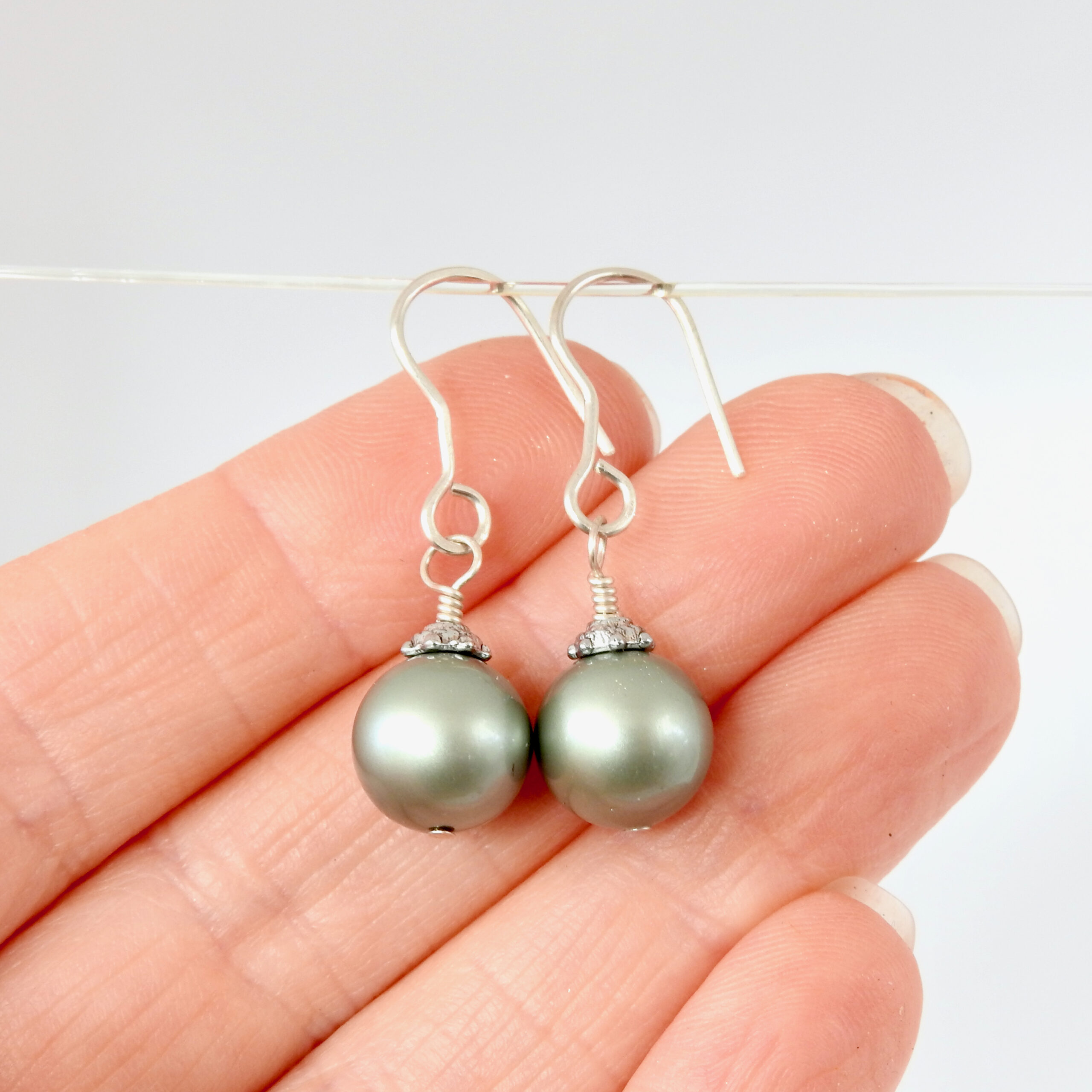 Green Christmas Bauble earrings_hand scale