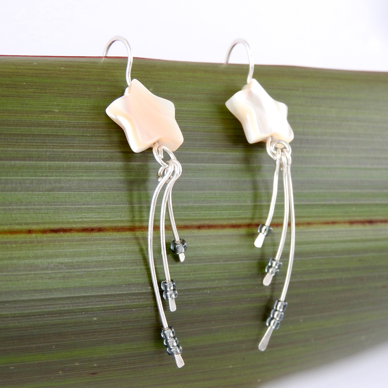 Side angle view of Wishing Star Earrings with three dangles