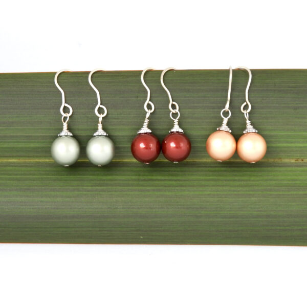 Trio Christmas Bauble Earrings_Square 3 different colours of Christmas Bauble earrings against flax_Main product image