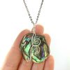 hand scale of NZ Paua Shell Necklace in Argentium Silver with 2 koru