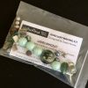 A selection of green and grey stone, acrylic and pearl beads