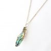 Curved long wedge paua shell necklace hanging from chain