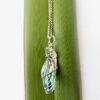 Recycled Silver wire wrapped Paua shell wedge necklace on flax leaf Product photo of curved long wedge paua shell necklace
