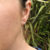Model wearing dangly two way leaf earrings