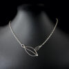 Necklace_Two Leaves with chain. Can be worn two different ways_on black model showing scale 2 way leaf necklace handmade from sustainable Sterling Silver
