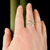 the adjustable ring can be loosened by gently pulling the leaves further apart