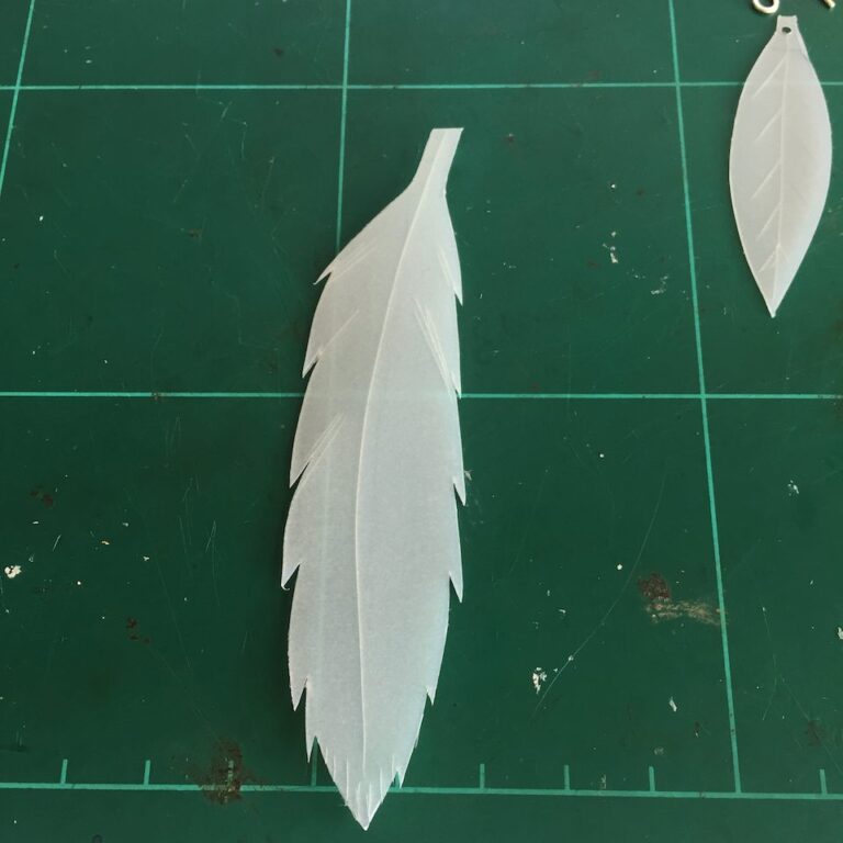 First milk bottle feather design with leaf in background