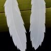 Close up of large feather earrings handcrafted from NZ milk bottles