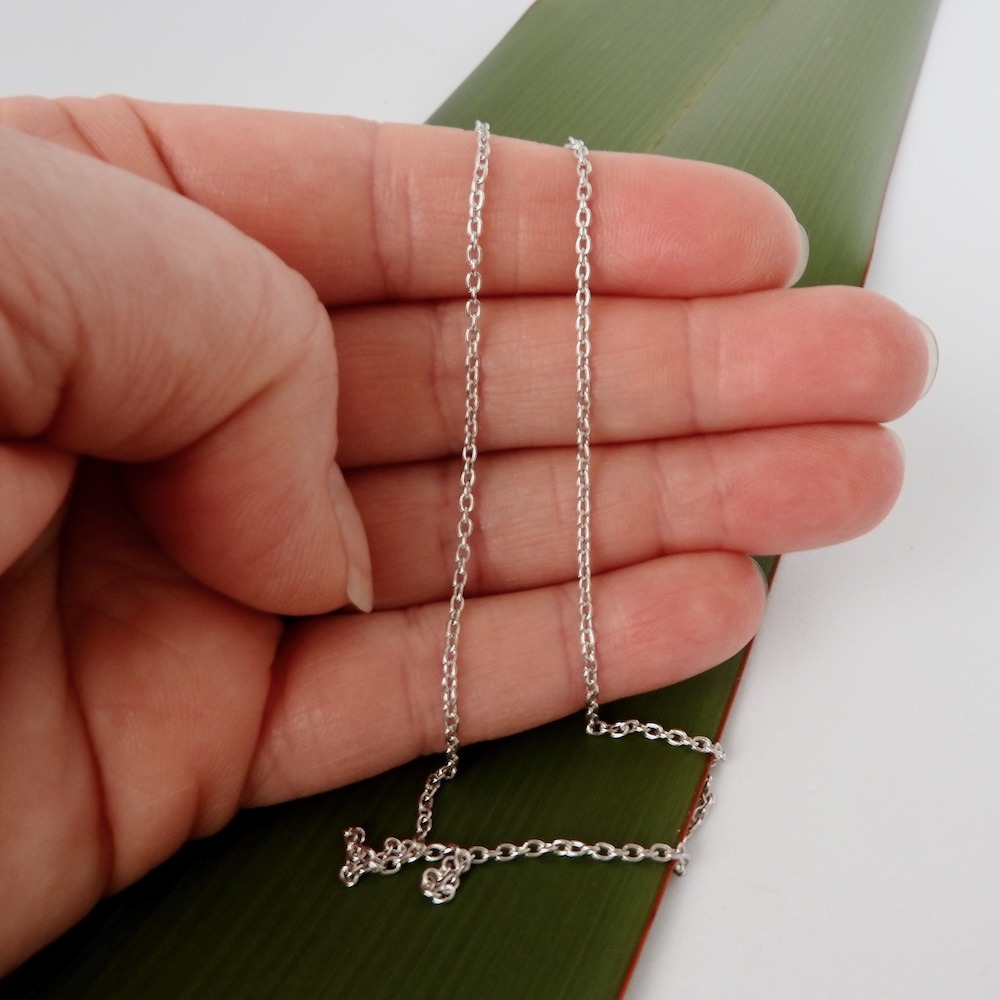 Rhodium plated Sterling Silver chain_hand scale on flax background