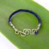 Great gift for him: Mens braided blue suede bracelet featuring a sustainably sourced Sterling Silver square double Koru