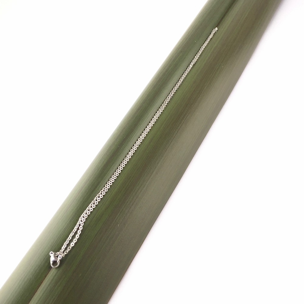 Stainless Steel chain full length against flax background