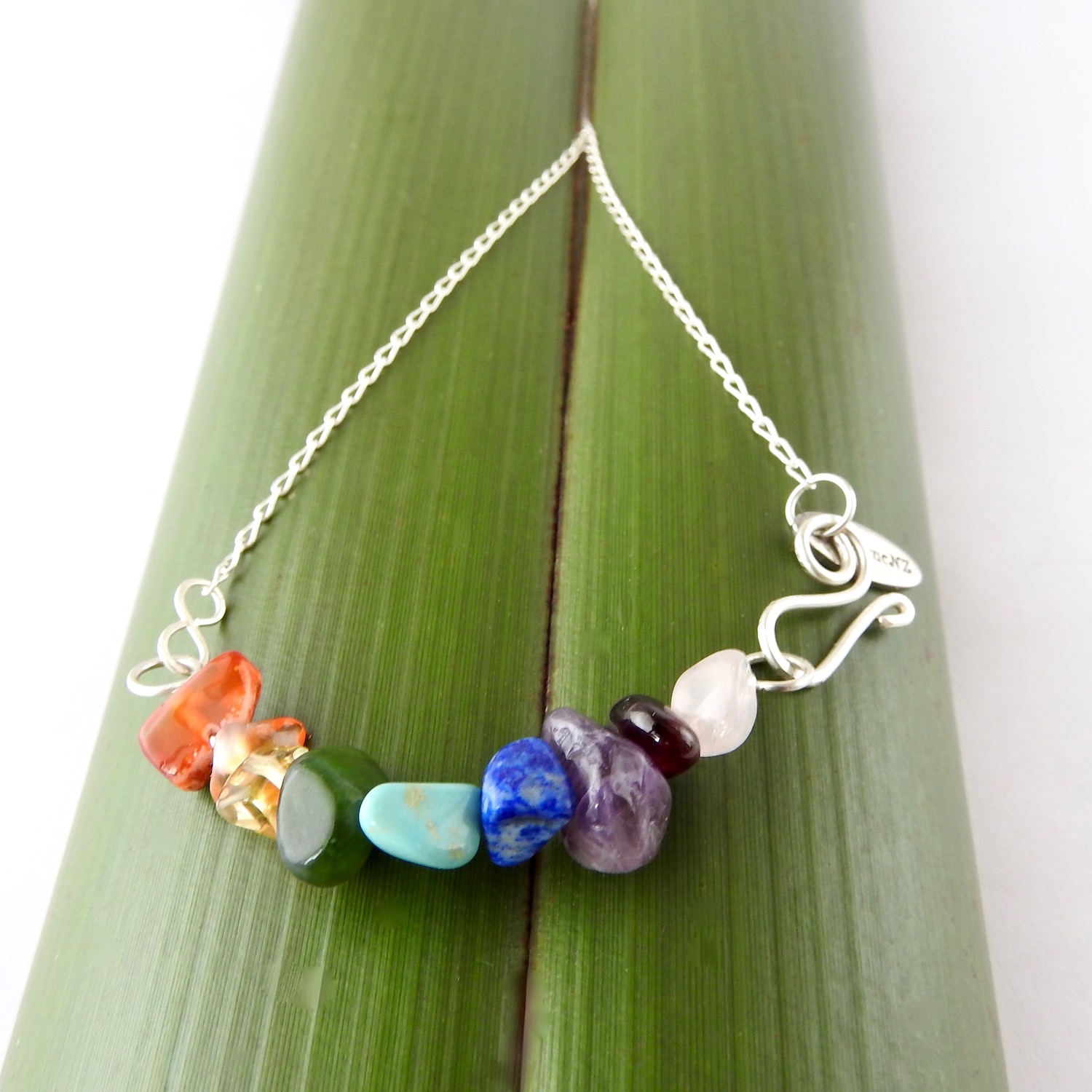 This necklace is handmade with recycled sterling silver and rainbow coloured semi precious stones