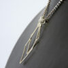 Side angled view of two diamonds ring holder necklace