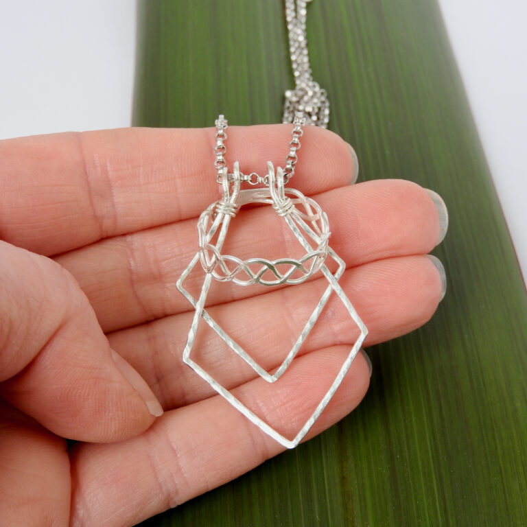 Hand scale of ring on geometric ring holder necklace