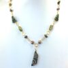 NZ Greenstone necklace wrapped with gold plated wire and featuring a single koru spiral flourish