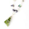 Close up of featured triangle of greenstone wire wrapped in sustainable silver with single koru