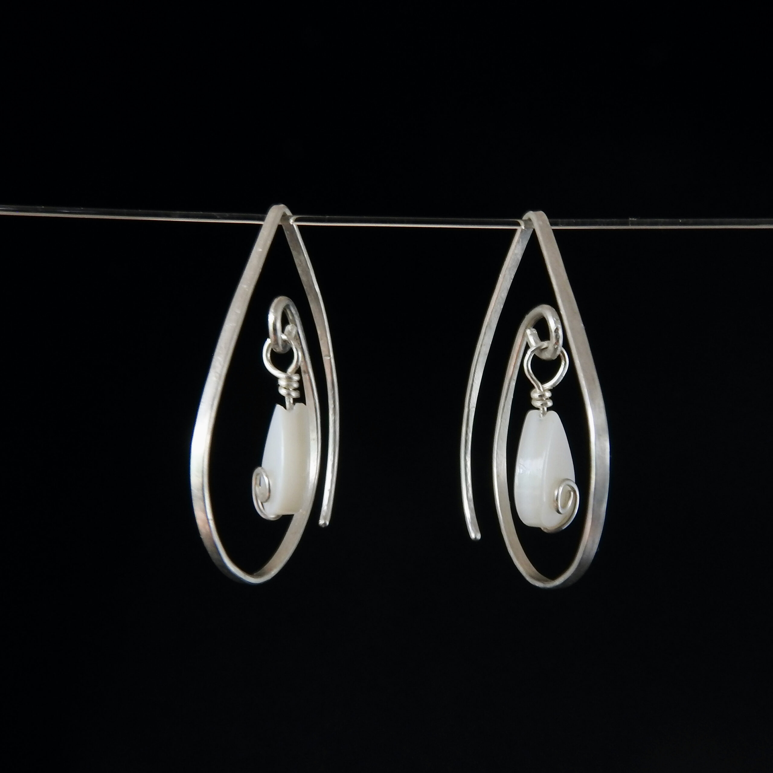 MOP TearDrop Earrings Hanging Black Background1