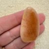 Back of teardrop Kauri Gum piece_Hand scale