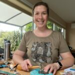 Me - Suzie Horne - Making and hammering a silver jewellery piece at my desk in my home studio